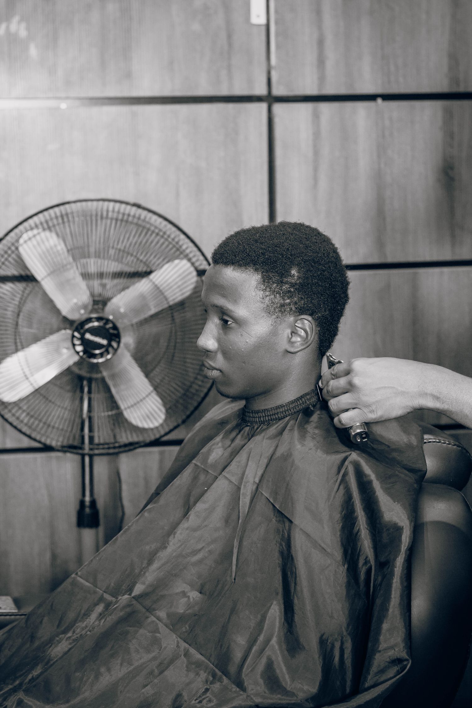 Client relaxing in the barber chair, black and white